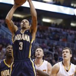  Indiana Pacers' George Hill (3) scores as Phoenix Suns' Goran Dragic (1), of Slovenia, and Miles Plumlee (22) and Pacers' Roy Hibbert, left, all look on during the first half of an NBA basketball game Wednesday, Jan. 22, 2014, in Phoenix. (AP Photo/Ross D. Franklin)