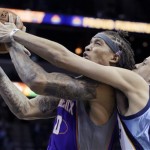 Phoenix Suns' Michael Beasley (0) goes to the basket in front of Memphis Grizzlies' Austin Daye (5) during first half of an NBA basketball game in Memphis, Tenn., Tuesday, Feb. 5, 2013. (AP Photo/Danny Johnston)