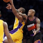 Phoenix Suns' P.J. Tucker, right, fouls Los Angeles Lakers' Kobe Bryant during the first half of an NBA basketball game on Tuesday, February 12, 2013, in Los Angeles. (AP Photo/Danny Moloshok)