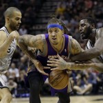 Phoenix Suns' Michael Beasley, center, is pressured by San Antonio Spurs' Tony Parker, left, of France, and DeJuan Blair, right, during the fourth quarter of an NBA basketball game, Saturday, Jan. 26, 2013, in San Antonio, Texas. San Antonio won 108-99. (AP Photo/Eric Gay)
