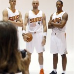 Phoenix Suns' Channing Frye, right, poses with teammates Marcin Gortat (4), of Poland, and rookie center Alex Len for team photographer Barry Gossage during the team's NBA basketball media day on Monday, Sept. 30, 2013, in Phoenix. The Suns announced that Frye has been cleared to join the team's training camp, a year after it was found that Frye would have to miss the entire basketball season because of an enlarged heart. (AP Photo/Ross D. Franklin)