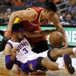 Houston Rockets' Jeremy Lin battles Phoenix Suns' Jared Dudley (3) for a loose ball during the first half of an NBA basketball game, Monday, April 15, 2013, in Phoenix. (AP Photo/Matt York)
