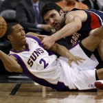Phoenix Suns' Wesley Johnson (2) tries to pass the ball as Atlanta Hawks' Zaza Pachulia, of Georgia, defends during the second half of an NBA basketball game, Friday, March 1, 2013, in Phoenix. The Suns won 92-87. (AP Photo/Matt York)