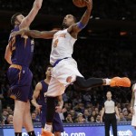 New York Knicks' J.R. Smith (8) drives past Phoenix Suns' Miles Plumlee (22) during the first half of an NBA basketball game Monday, Jan. 13, 2014, in New York. (AP Photo/Frank Franklin II)