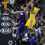 Phoenix Suns center Hamed Haddadi, left, of Iran, blocks a shot by Denver Nuggets forward Jordan Hamilton, right, in the second half of an NBA basketball game on Wednesday, April 17, 2013, in Denver. The Nuggets won 118-98. (AP Photo/Chris Schneider)