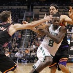 Boston Celtics forward Jeff Green, center, drives between Phoenix Suns guard Goran Dragic, front, of Slovenia, and forward Luis Scola, rear, of Argentina, in the first half of an NBA basketball game, Friday, Feb. 22, 2013, in Phoenix. (AP Photo/Paul Connors)