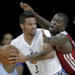 Phoenix Suns' Chris Babb, left, is pressured by Miami Heat forward James Ennis in the fourth quarter of an NBA Summer League basketball game, Sunday, July 21, 2013, in Las Vegas. (AP Photo/Julie Jacobson)