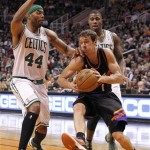 Phoenix Suns guard Goran Dragic, center, of Slovenia, drives to the basket around Boston Celtics forward Chris Wilcox, left, and Terrence Williams, right, in the second half of an NBA basketball game, Friday, Feb. 22, 2013, in Phoenix. The Celtics won 113-88. (AP Photo/Paul Connors)