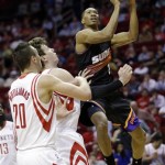 Phoenix Suns' Wesley Johnson (2) shoots over Houston Rockets' Donatas Motiejunas (20) and Omer Asik during the first quarter of an NBA basketball game Wednesday, March 13, 2013, in Houston. (AP Photo/David J. Phillip)