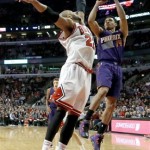 Phoenix Suns guard Gerald Green (14) shoots over Chicago Bulls forward Taj Gibson (22) during the second half of an NBA basketball game, Tuesday, Jan. 7, 2014, in Chicago. The Bulls won 92-87. (AP Photo/Charles Rex Arbogast)
