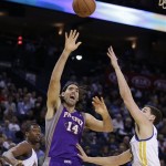 Phoenix Sun's Luis Scola (14) shoots against Golden State Warriors' Klay Thompson, right, during the first half of an NBA basketball game Wednesday, Feb. 20, 2013, in Oakland, Calif. (AP Photo/Ben Margot)