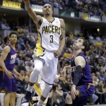 Indiana Pacers guard George Hill, left, shoots over Phoenix Suns guard Goran Dragic in the second of an NBA basketball game in Indianapolis, Thursday, Jan. 30, 2014. The Suns defeated the Pacers 102-94. (AP Photo)