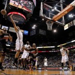 Brooklyn Nets' Brook Lopez battles Phoenix Suns' Mamed Haddadi (98), of Iran, for the rebound during the second half of an NBA basketball game, Sunday, March 24, 2013, in Phoenix. The Nets won 102-100.(AP Photo/Matt York)
