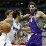 Minnesota Timberwolves' Ricky Rubio, left, of Spain, drives around Phoenix Suns' Luis Scola, of Argentina, in the first quarter of an NBA basketball game on Saturday, April 13, 2013, in Minneapolis. (AP Photo/Jim Mone)