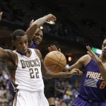 Phoenix Suns' Channing Frye (8) and Milwaukee Bucks' Khris Middleton (22) watch a loose ball during the second half of an NBA basketball game Wednesday, Jan. 29, 2014, in Milwaukee. (AP Photo/Jeffrey Phelps)
