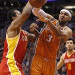 Phoenix Suns forward Jared Dudley, right, passes the ball around Houston Rockets forward Greg Smith, left, during the second half of an NBA basketball game Saturday, March 9, 2013, in Phoenix. The Suns won 107-105.(AP Photo/Paul Connors)
