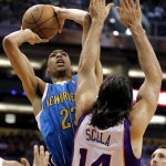 New Orleans Hornets' Anthony Davis (23) shoots over Phoenix Suns' Luis Scola, of Argentina, during the first half of an NBA basketball game, Sunday, April 7, 2013, in Phoenix. (AP Photo/Matt York)