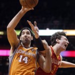 Phoenix Suns forward Luis Scola, left of Argentina, grabs control of a rebound against Houston Rockets center Omer Asik, of Turkey, during the first half of an NBA basketball game Saturday, March 9, 2013, in Phoenix. (AP Photo/Paul Connors)
