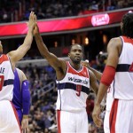 Washington Wizards forward Martell Webster (9) reacts with teammates Garrett Temple (17) and Nene (42), of Brazil, during the second half of an NBA basketball game against the Phoenix Suns, Saturday, March 16, 2013, in Washington. The Wizards won 127-105. (AP Photo/Nick Wass)
