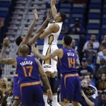 New Orleans Pelicans power forward Anthony Davis (23) shoots over Phoenix Suns small forward P.J. Tucker (17) and Phoenix Suns shooting guard Gerald Green (14) in the first half of an NBA basketball game in New Orleans, Tuesday, Nov. 5, 2013. (AP Photo/Gerald Herbert)