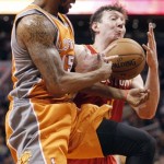 Phoenix Suns forward Marcus Morris, left, battle Houston Rockets center Omer Asik, right, of Turkey for a rebound during the second half of an NBA basketball game Saturday, March 9, 2013, in Phoenix. The Suns won 107-105. (AP Photo/Paul Connors)
