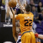  Washington Wizards' Trevor Ariza, left, takes an offense charge from Phoenix Suns' Miles Plumlee (22) during the first half of an NBA basketball game, Friday, Jan. 24, 2014, in Phoenix. (AP Photo/Ross D. Franklin)