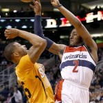  Washington Wizards' John Wall (2) passes the ball off as Phoenix Suns' Marcus Morris, left, defends during the first half of an NBA basketball game, Friday, Jan. 24, 2014, in Phoenix. (AP Photo/Ross D. Franklin)
