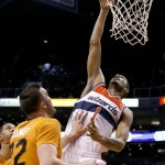  Washington Wizards' Trevor Ariza (1) scores in front of Phoenix Suns' Miles Plumlee, left, during the first half of an NBA basketball game, Friday, Jan. 24, 2014, in Phoenix. (AP Photo/Ross D. Franklin)