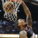 Phoenix Suns' Michael Beasley makes a reverse dunk against the Los Angeles Lakers in the second half of an NBA basketball game on Monday, March 18, 2013, in Phoenix. The Suns defeated the Lakers 99-76. (AP Photo/Ross D. Franklin)