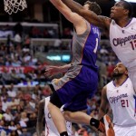 Los Angeles Clippers guard Eric Bledsoe, right, blocks the shot of Phoenix Suns guard Goran Dragic, of Slovenia, as Clipper forward Ronny Turiaf (21) looks on in the second half of an NBA basketball game in Los Angeles on Wednesday, April 3, 2013. (AP Photo/Richard Hartog)