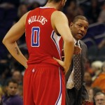 Los Angeles Clippers head coach Doc Rivers, right, talks to Byron Mullens (0) in the second quarter of an NBA preseason basketball game against the Phoenix Suns on Tuesday, Oct. 15, 2013, in Phoenix. (AP Photo/Rick Scuteri)