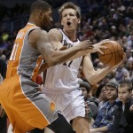 Milwaukee Bucks' Mike Dunleavy, right, drives against Phoenix Suns' Markieff Morris (11) during the first half of an NBA basketball game Tuesday, Jan. 8, 2013, in Milwaukee. (AP Photo/Jeffrey Phelps)