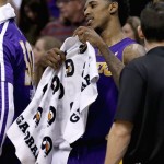  Los Angeles Lakers' Nick Young picks up a towel on the team bench after getting into a scuffle with Phoenix Suns players during the first half of an NBA basketball game Wednesday, Jan. 15, 2014, in Phoenix. Young was ejected from the game. (AP Photo/Ross D. Franklin)