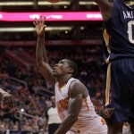 Phoenix Suns guard Eric Bledsoe (2), left, scores on New Orleans Pelicans forward Al-Farouq Aminu (0) in the third quarter during an NBA basketball game on Sunday, Nov. 10, 2013, in Phoenix. The Suns defeated the Pelicans 101-94. (AP Photo/Rick Scuteri)