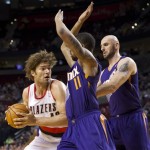 Portland Trail Blazers center Robin Lopez (42) tries to get past Phoenix Suns' Markieff Morris and Marcin Gortat, right, during an NBA preseason basketball game Wednesday, Oct. 9, 2013, in Portland, Ore. AP Photo/The Oregonian, Bruce Ely)