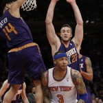 New York Knicks' Kenyon Martin (3) protects the ball from Phoenix Suns' Miles Plumlee (22) and Gerald Green (14) during the first half of an NBA basketball game Monday, Jan. 13, 2014, in New York. (AP Photo/Frank Franklin II)