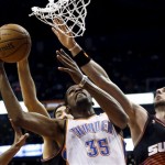 Oklahoma City Thunder's Kevin Durant (35) gets fouled by Phoenix Suns' Marcin Gortat, right, of Poland, as he goes up for a shot during the first half in an NBA basketball game, Sunday, Feb. 10, 2013, in Phoenix. (AP Photo/Ross D. Franklin)

