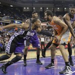 Phoenix Suns center Hamed Haddadi tries to maintain possession of the ball between Sacramento Kings' Marcus Cousins, front left, DeMarcus Cousins, rear left, and Patrick Patterson during the first quarter of an NBA basketball game in Sacramento, Calif., Friday, March 8, 2013. (AP Photo/Rich Pedroncelli)