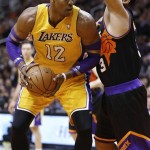 Los Angeles Lakers' Dwight Howard (12) backs down Phoenix Suns' Jared Dudley during the first half on an NBA basketball game, Wednesday, Jan. 30, 2013, in Phoenix. (AP Photo/Matt York)