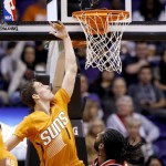  Phoenix Suns' Goran Dragic (1), of Slovenia, scores against Washington Wizards' Nene during the first half of an NBA basketball game, Friday, Jan. 24, 2014, in Phoenix. (AP Photo/Ross D. Franklin)