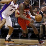 Washington Wizards' Martell Webster (9) drives past Phoenix Suns' Wesley Johnson (2) during the first half of an NBA basketball game on Wednesday, March 20, 2013, in Phoenix. (AP Photo/Matt York)