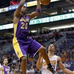  Los Angeles Lakers' Jodie Meeks (20) dunks as he gets past Phoenix Suns' Gerald Green, right, during the first half of an NBA basketball game Wednesday, Jan. 15, 2014, in Phoenix. (AP Photo/Ross D. Franklin)