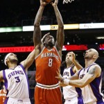 Milwaukee Bucks' Larry Sanders (8) scores against Phoenix Suns' Jared Dudley (3), Marcin Gortat, right, of Poland, and Luis Scola, of Argentina, in the first half during an NBA basketball game on Thursday, Jan. 17, 2013, in Phoenix. (AP Photo/Ross D. Franklin)
