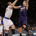 Phoenix Suns' Goran Dragic (1) shoots over New York Knicks' Andrea Bargnani (77) during the overtime period of an NBA basketball game Monday, Jan. 13, 2014, in New York. The Knicks won the game 98-96. (AP Photo/Frank Franklin II)