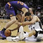 San Antonio Spurs' Jeff Ayres, right, chases a loose ball against Phoenix Suns' Miles Plumlee during the second half of an NBA preseason basketball game on Sunday, Oct. 13, 2013, in San Antonio. Phoenix won 106-99. (AP Photo/Darren Abate)