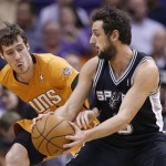 Phoenix Suns' Goran Dragic, left, of Slovenia, reaches for the basketball as he tries to knock the ball away from San Antonio Spurs' Marco Belinelli, right, of Italy, during the first half of an NBA basketball game, Friday, Feb. 21, 2014, in Phoenix. (AP Photo/Ross D. Franklin)