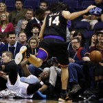 Oklahoma City Thunder's Kevin Durant, bottom left, collides with Phoenix Suns' Luis Scola (14), of Argentina, as both go after a loose ball during the first half in an NBA basketball game, Sunday, Feb. 10, 2013, in Phoenix. (AP Photo/Ross D. Franklin)

