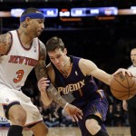 New York Knicks' Kenyon Martin (3) defends Phoenix Suns' Goran Dragic (1) during the overtime period of an NBA basketball game Monday, Jan. 13, 2014, in New York. The Knicks won the game 98-96. (AP Photo/Frank Franklin II)