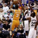 Phoenix Suns' Wesley Johnson (2) shoots as Utah Jazz's Randy Foye (8) and Al Jefferson (25) defend during the second half of an NBA basketball game, Wednesday, March 27, 2013, in Salt Lake City. The Jazz won 103-88. (AP Photo/Rick Bowmer)