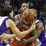 Milwaukee Bucks' Monta Ellis is double-teamed by Phoenix Suns' Luis Scola, left, of Argentina, and P.J. Tucker, right, in the first half during an NBA basketball game on Thursday, Jan. 17, 2013, in Phoenix. (AP Photo/Ross D. Franklin)